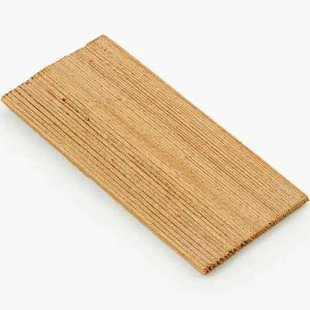 Close-up of weathered cedar shake roof shingles, showcasing natural wood grain and rustic texture